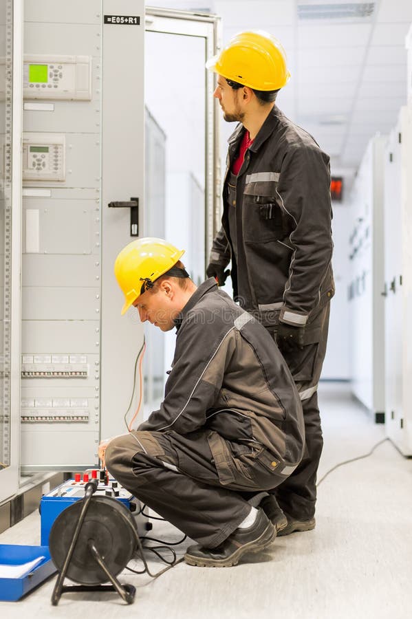 Field service engineers inspect system with relay test set equip royalty free stock images