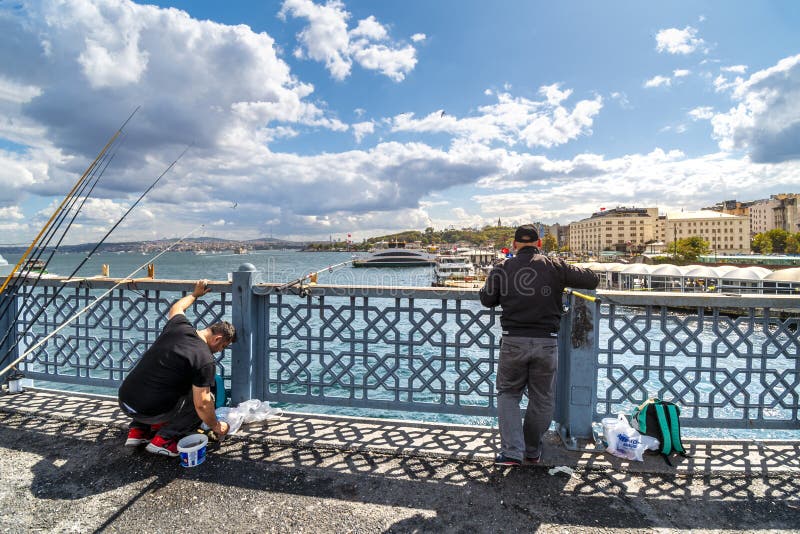 Two fisherman with rods fish from the Galata Bridge over the Bosphorus River in Istanbul, Turkey. royalty free stock photos Two fisherman with rods fish from the Galata Bridge over the Bosphorus River in Istanbul, Turkey. royalty free stock photos