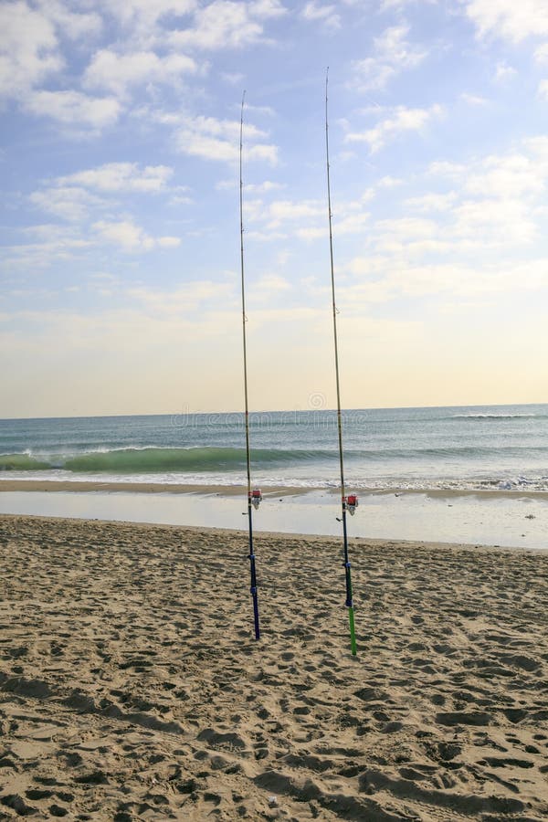 Angling rods at the beach stock photo. Image of ocean, sand 739000