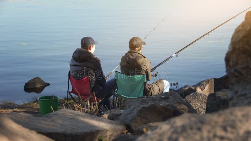 Two friends fishing to escape stressed city life, common interests, free time.