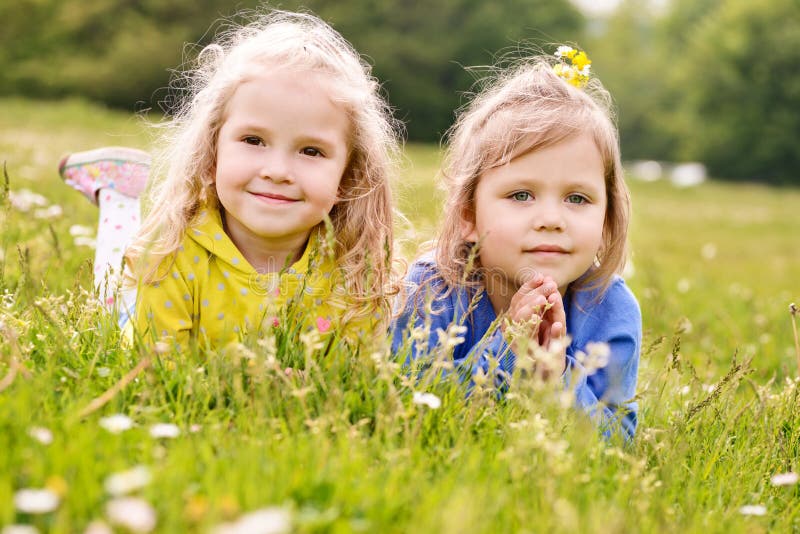 Happy Girls Twin Sisters Kissing and Laughing in the Summer Stock Image ...