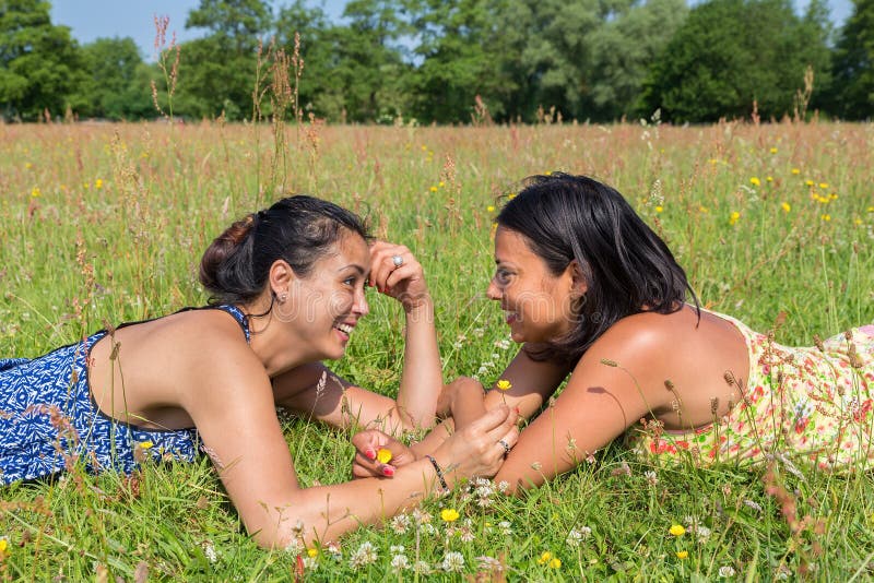 Two Friends Lying Together In Green Meadow Stock Image Image Of