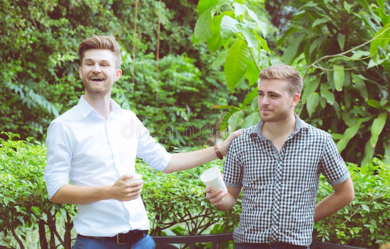 Two Friends Men Talking Sitting In A Garden Stock Photo Image Of