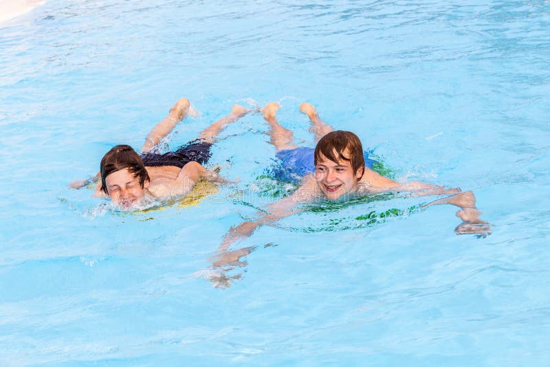 Two Friends Swimming in the Pool Stock Image Image of male, playing 24934333
