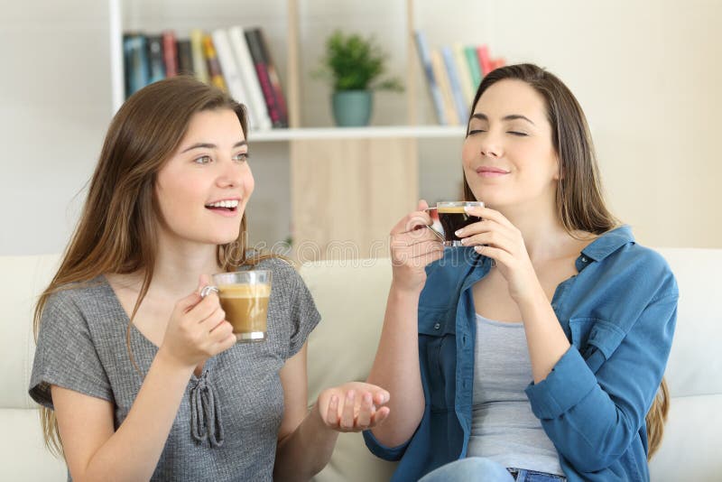 Two friends talking and enjoying a coffee cup