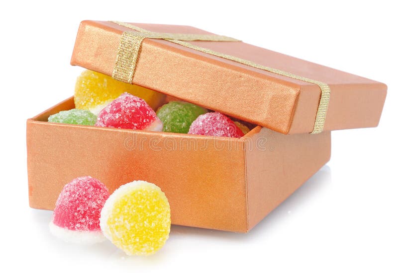 Two fruit candy lie near box