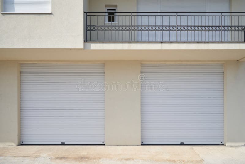 Two Garages with White Garage Doors in a Residential Building Stock