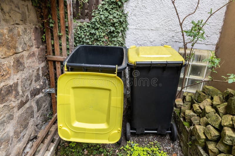 Two Garbage Cans for Plastic are in the Yard Stock Photo Image of