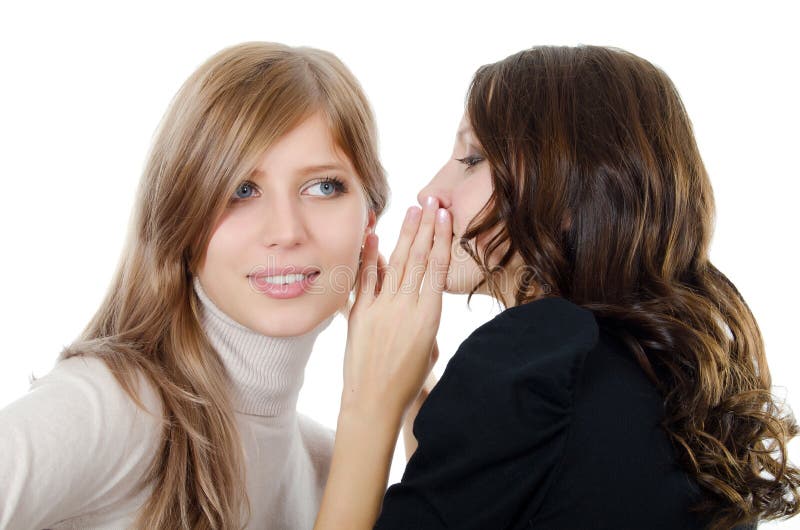 Two girl-friends tell gossips on an ear isolated