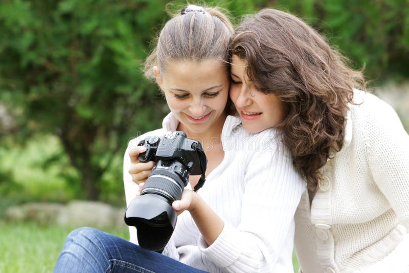 Two girl looking with digital camera