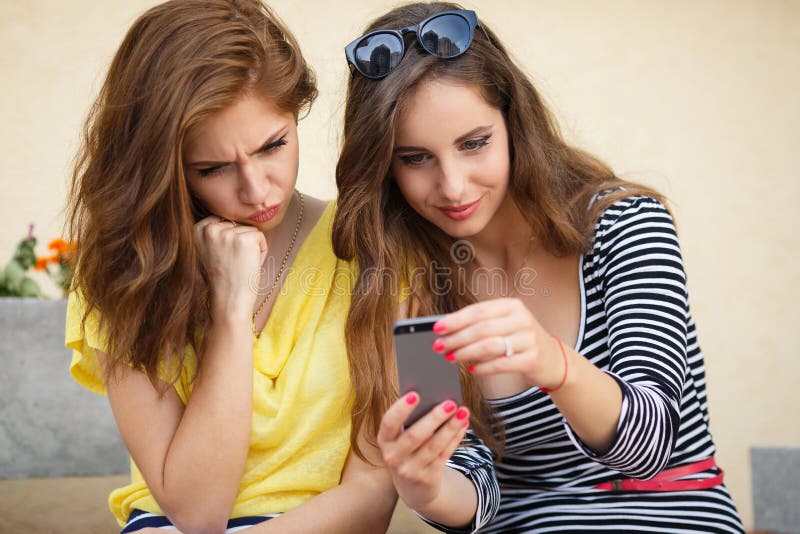 Two Girlfriends Looking Photos On Mobile Phone Stock Image Image Of