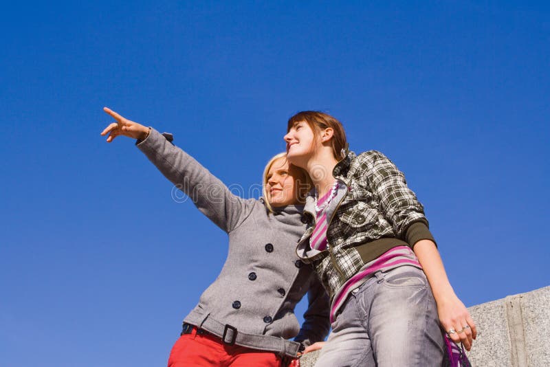 Two girls against blue sky