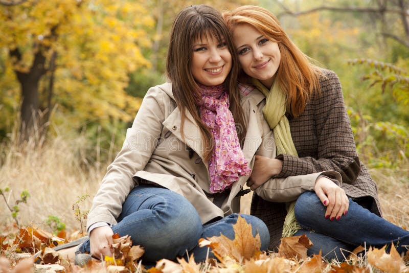 Two girls in the autumn park.