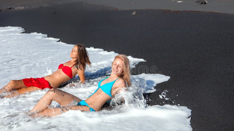 Two girls on the Beach with black sand