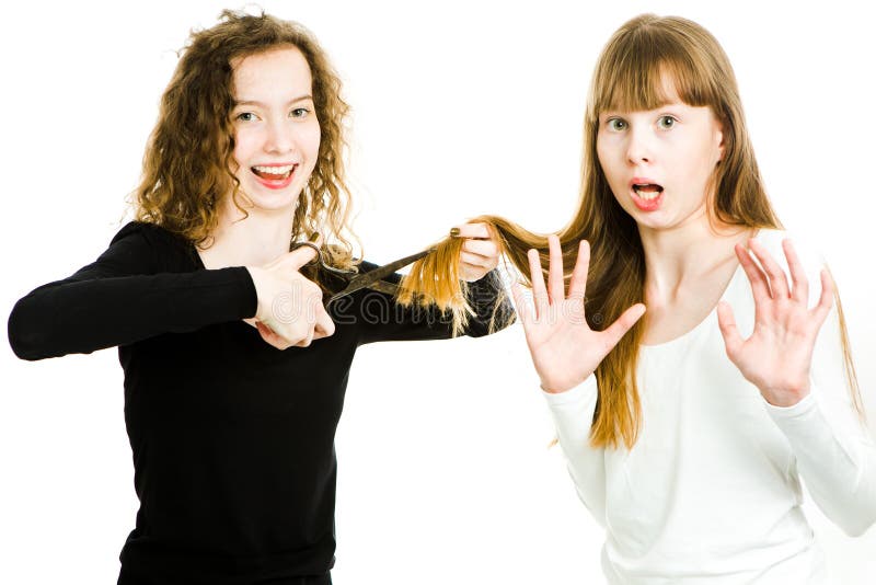 Two girls with blond hairs and scissors, one going to cut hairs stock images Two girls with blond hairs and scissors, one going to cut hairs stock images