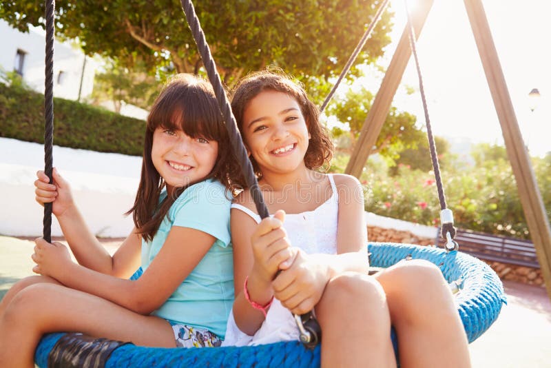 Two Girls Having Fun On Swing In Playground Stock Image Image Of