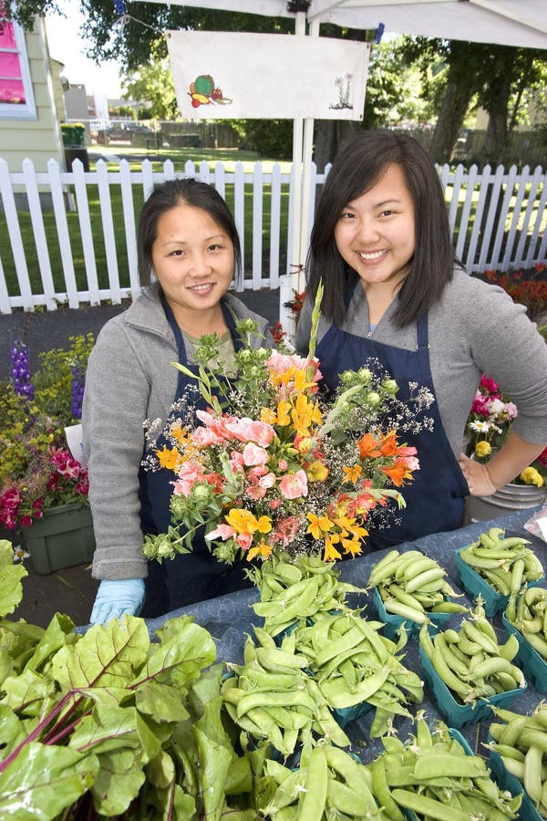 Two Girls Holding Flowers - Vertical