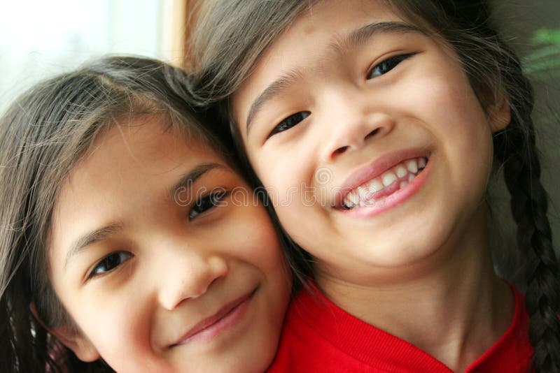 Two girls hugging and smiling