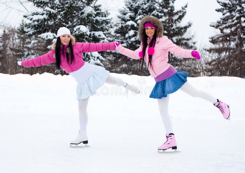 Two girls ice skating