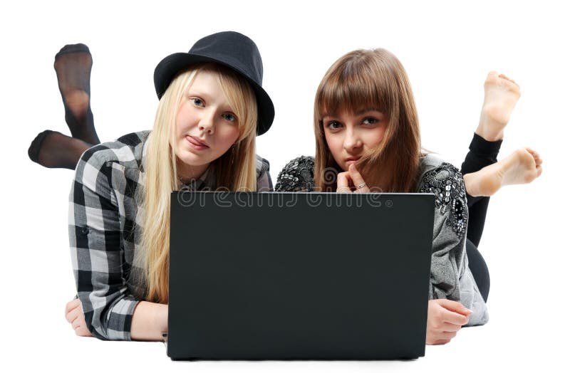 Two girls lies with computer