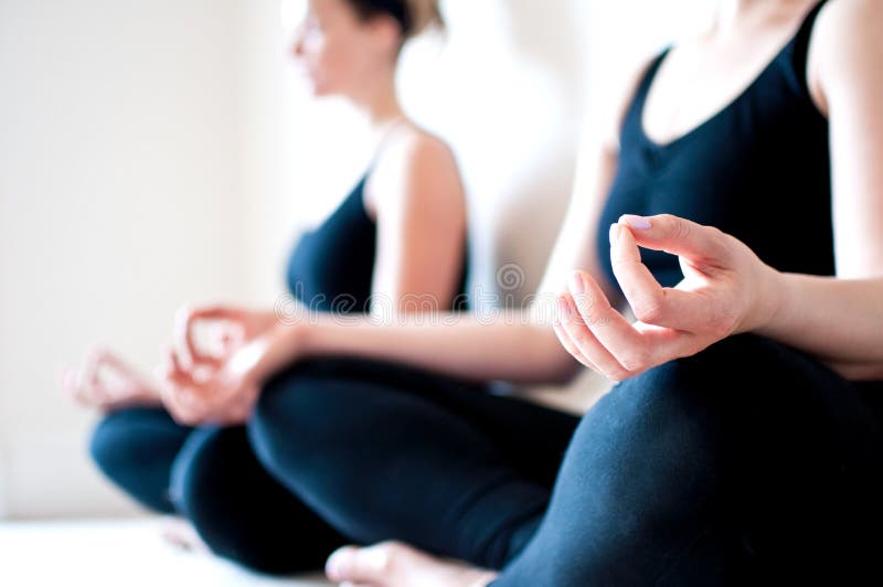 Two Girls Sit Cross Legged in a Yoga Pose Stock Photo Image of health