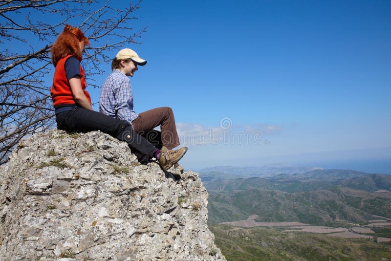 Two girls sitting on a rock