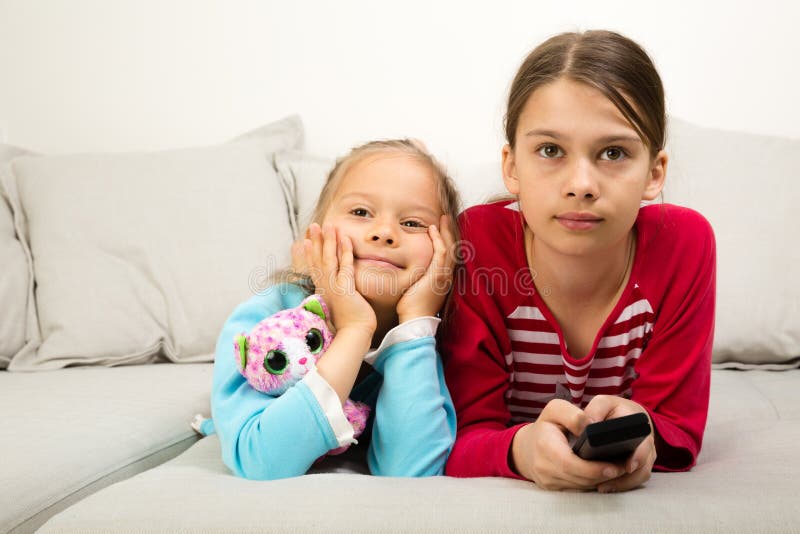 Two Girls Watching TV stock image. Image of young, female 119669473