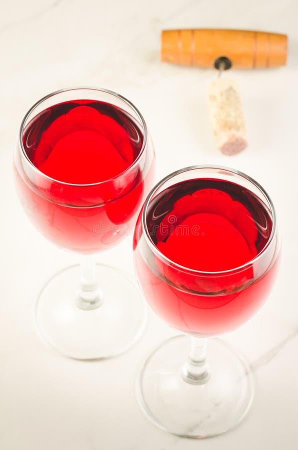 Two glass of red wine and corkscrew on white background/Two glass of red wine and corkscrew on white background. Top view stock photography Two glass of red wine and corkscrew on white background/Two glass of red wine and corkscrew on white background. Top view stock photography