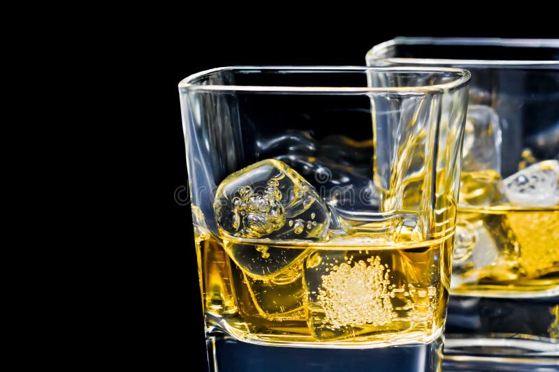 Two glasses of alcoholic drink on black background