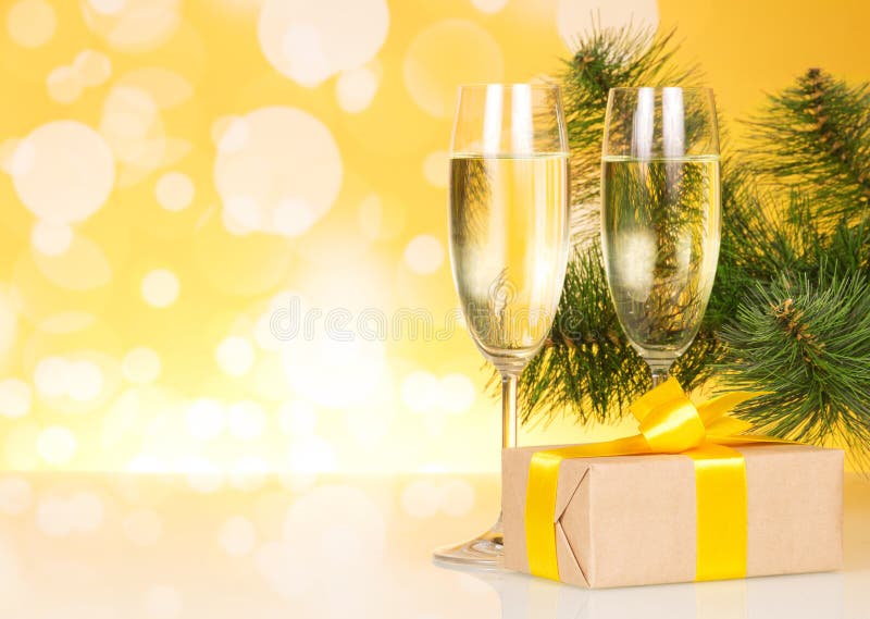 Two glasses with champagne and gift on background stock images Two glasses with champagne and gift on background stock images
