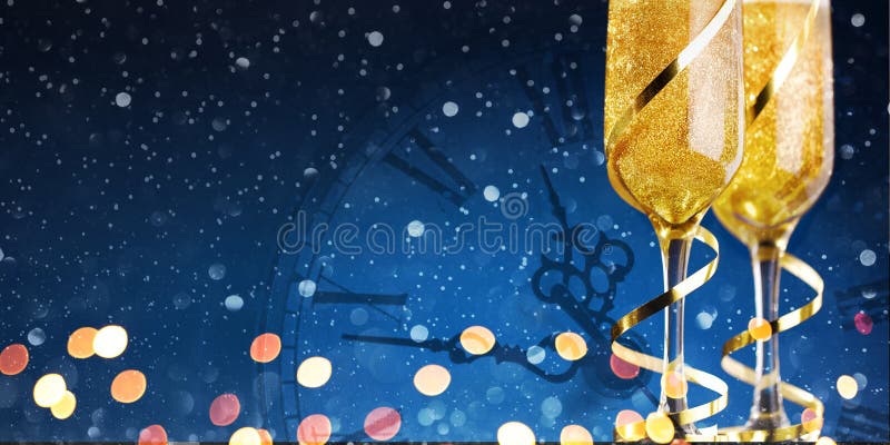 Two glasses of champagne with gold ribbon and gift on dark background with lights