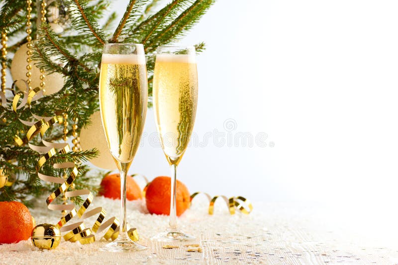 Two glasses of champagne ready to bring New Year on Christmas tree background royalty free stock photography Two glasses of champagne ready to bring New Year on Christmas tree background royalty free stock photography