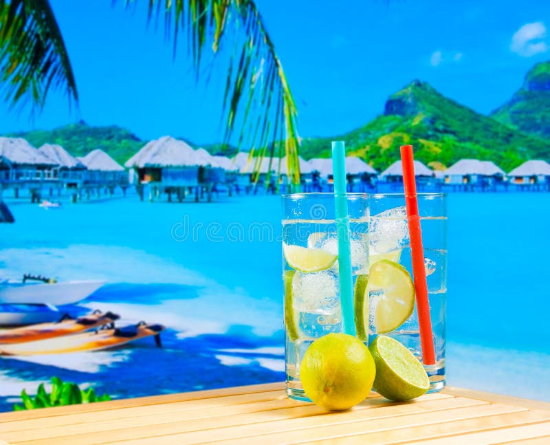 Two Glasses Of Cocktail With Lime Slice On Blur Beach Stock Image