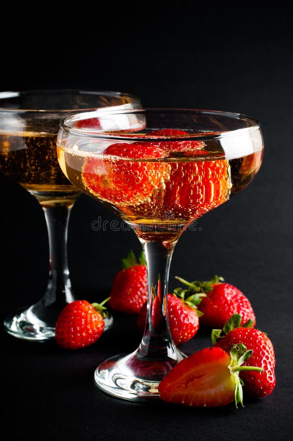 Two glasses of cold champagne with strawberries