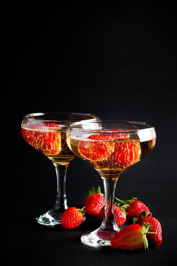 Two glasses of cold champagne with strawberries