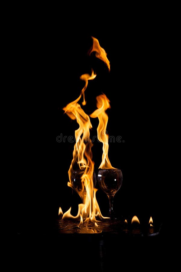 Two glasses and a flame stock image. Image of energy 231139259