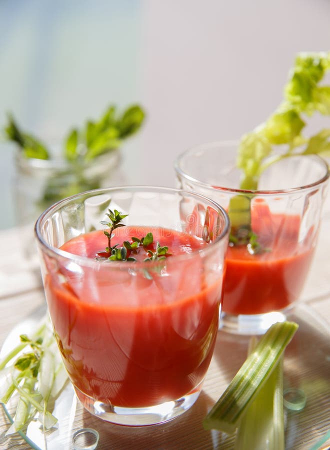 Two Glasses of Fresh Tomato Juice with Thyme and Celery. Stock Image