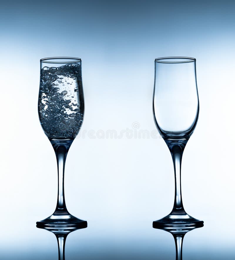 Two glasses on gradient white and blue background stock photo