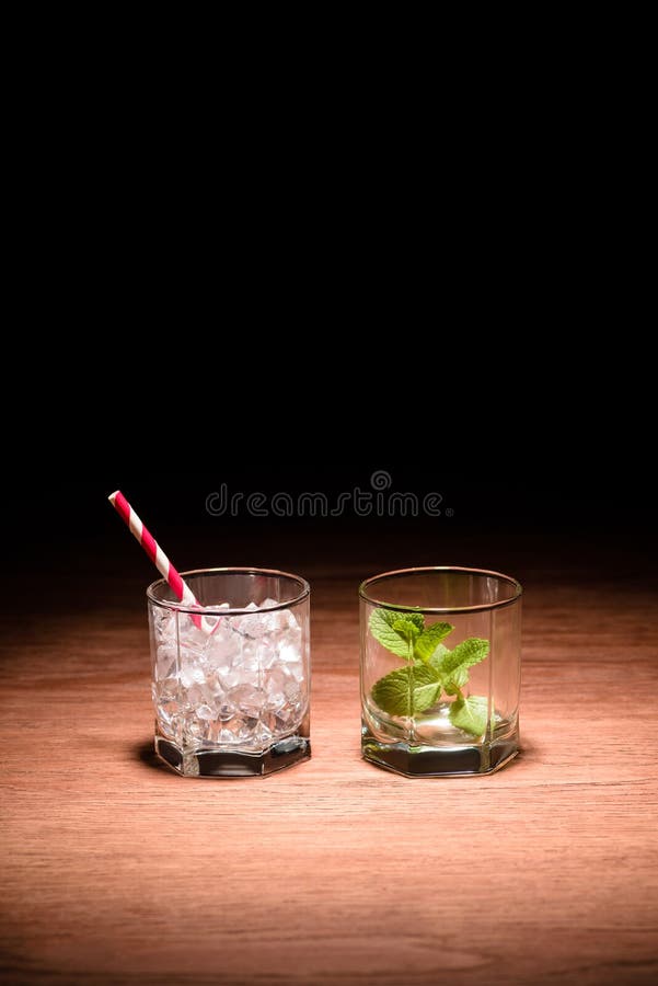 two glasses with ice cubes and mint for alcohol drinks