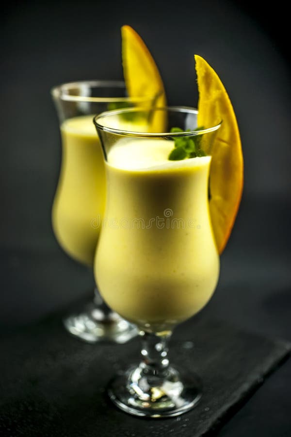 Two glasses of mango lassi stock photo. Image of cuisine 79958154