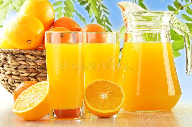 Two glasses of orange juice and fruits