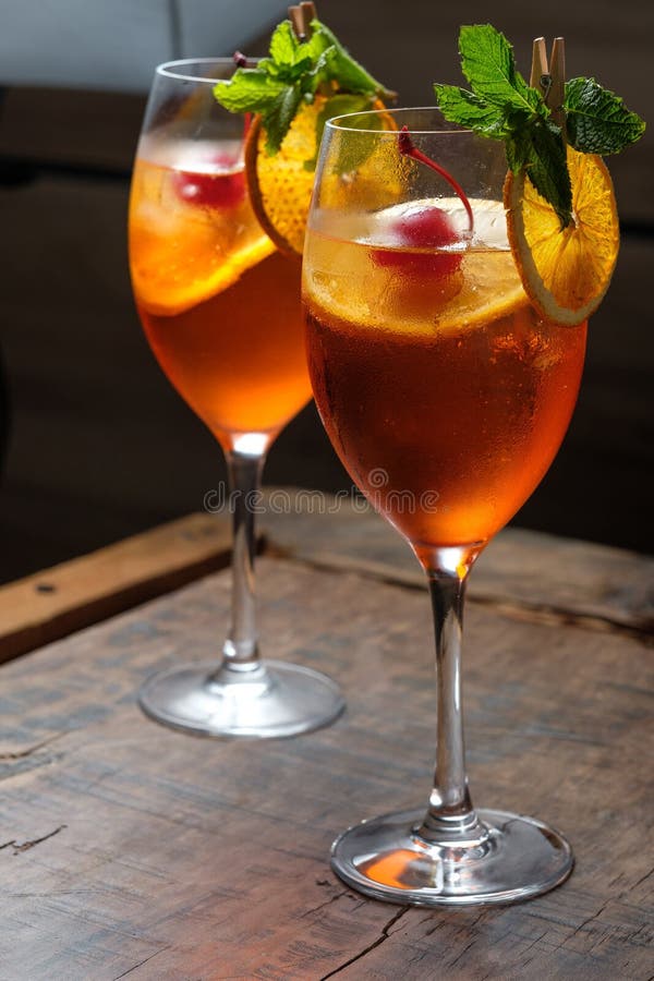 Two Glasses of Red Cocktail with Orange Slice and Cherry Stock Photo