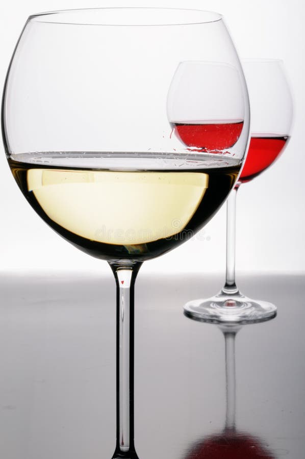 Two glasses of red and white wine royalty free stock photos