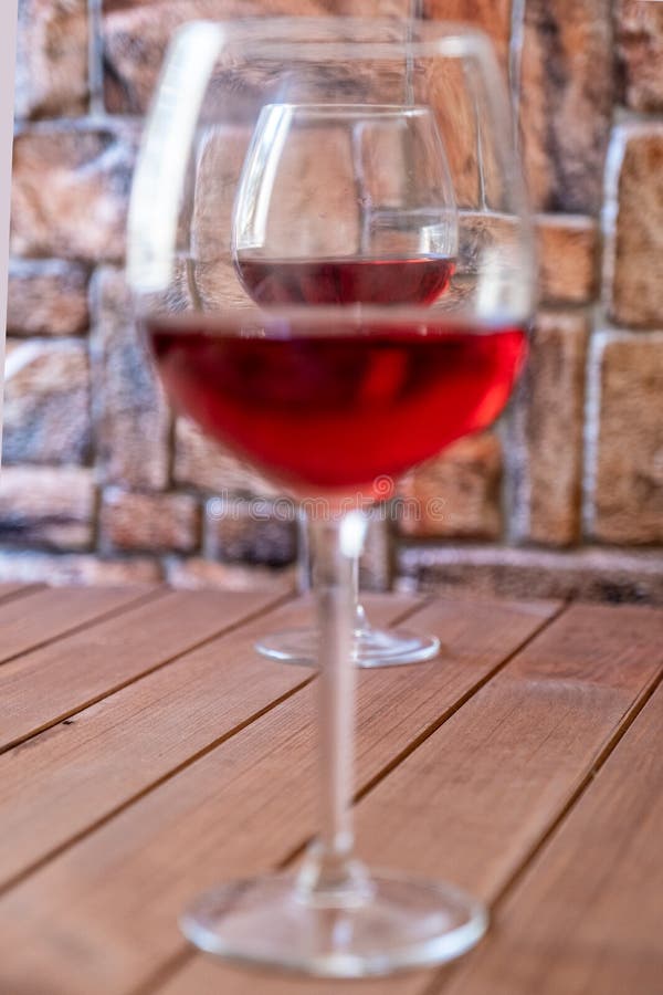 Two Red Wine Glasses on a White Background, One Glass Half Full the