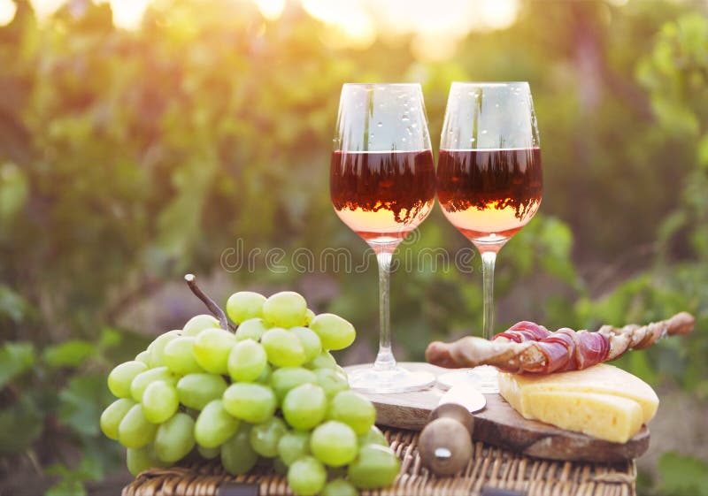 Two Glasses of Rose Wine with Bread, Meat, Grape and Cheese Stock Image