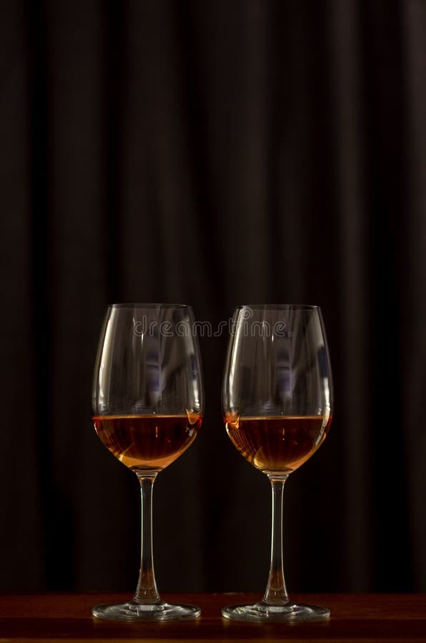 Two glasses of Rose wine on wooden table to celebrate for a couple stock photography Two glasses of Rose wine on wooden table to celebrate for a couple stock photography