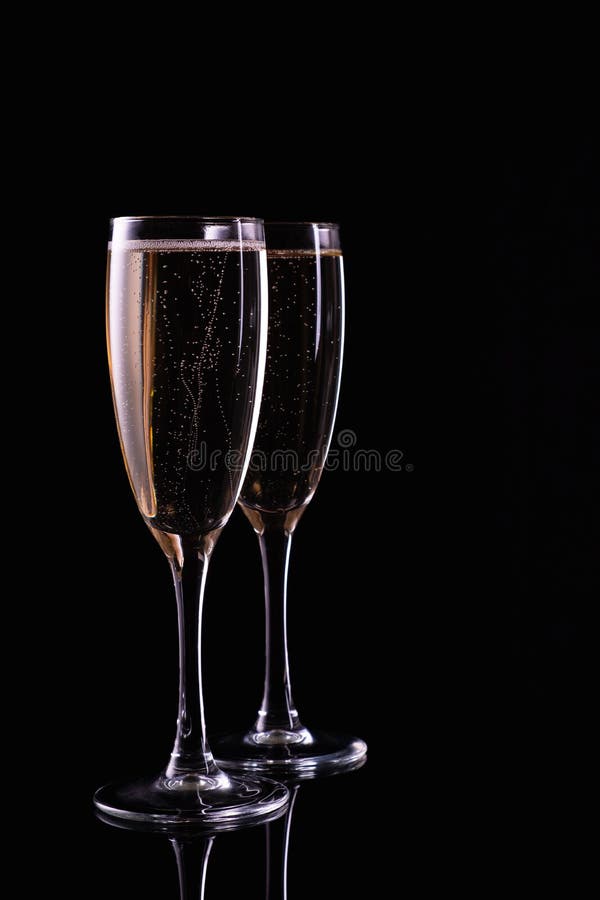 Two Glasses with White Wine Champagne on a Black Background Stock Photo