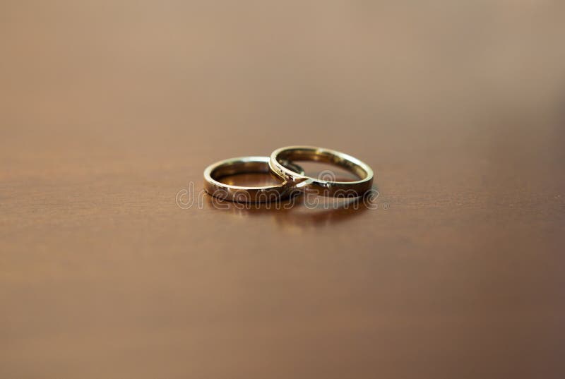 Two Gold Wedding Rings On Wooden Table Stock Image - Image ...