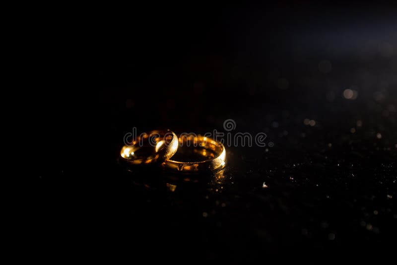Two Golden Wedding Rings on Black Background Stock Photo Image of