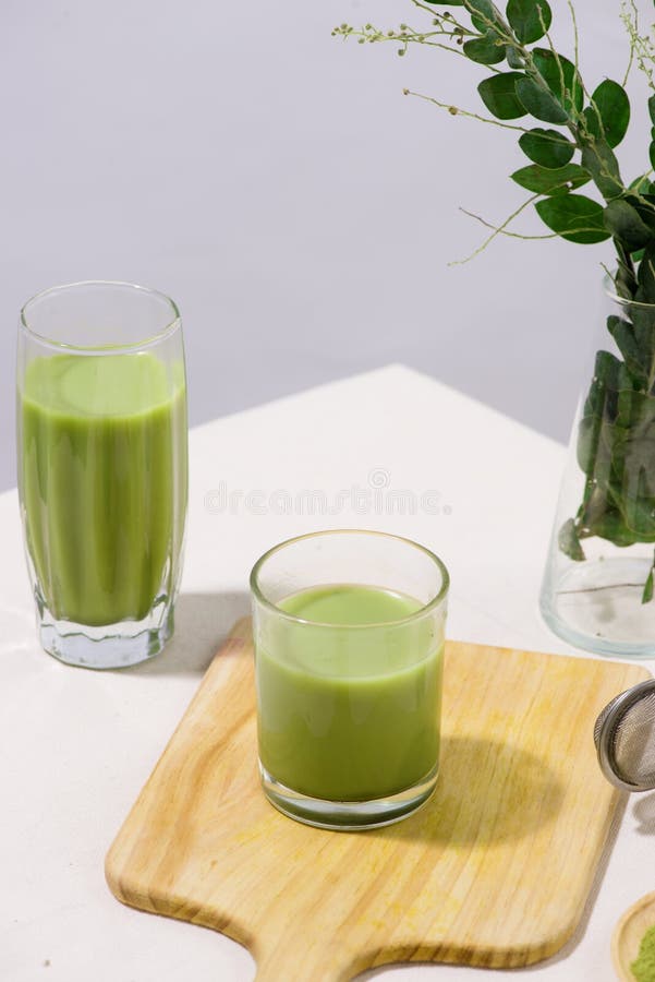 Two Green Tea Glasses on White Table. Still Life Drink Stock Photo